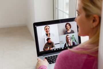 Woman video conferencing with tutor on laptop at home. Distance education concept.