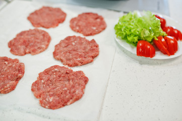 Сooking burgers in the kitchen at home during quarantine time.