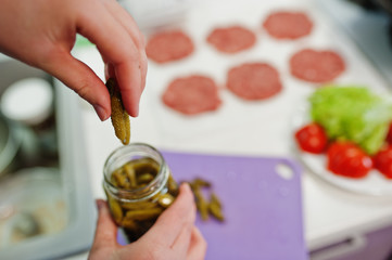 Сooking burgers in the kitchen at home during quarantine time.