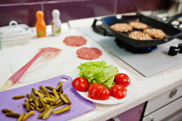 Сooking burgers in the kitchen at home during quarantine time.