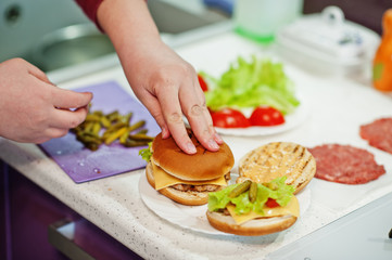 Сooking burgers in the kitchen at home during quarantine time.