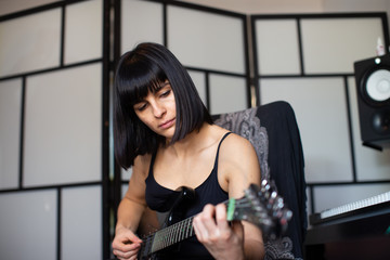 woman learning guitar