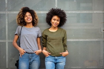 two young african american woman smiling with afro hair
