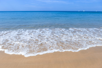 Fototapeta na wymiar Summer beach, outdoor day light, white wave on fine sand beach, holiday or vacation destination, south of Thailand, tropical beach