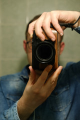 Fototapeta premium young man holding camera
