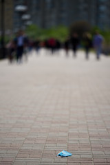 A medical mask lies on the sidewalk, on the asphalt. end of a quarantine. cancellation of a coronavirus. there is no pandemic. strike. People are tired of covid-19. soon finish. stop