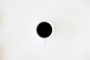 cup of hot black coffee on white table background.  Work from home concept.