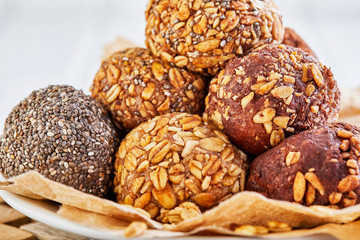 Obraz na płótnie Canvas Healthy Organic Energy balls Muesli Bites with Nuts, Cocoa, Chia and Honey - Vegan Vegetarian Raw Snacks or Food. copy space. Close-up