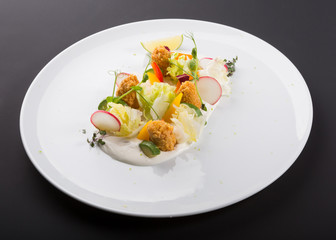 Elegant light vegetable salad with fried meat in tempura