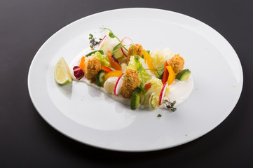 Elegant light vegetable salad with fried meat in tempura