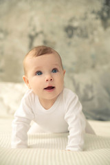 The kid with blue eyes studies everything and smiles.