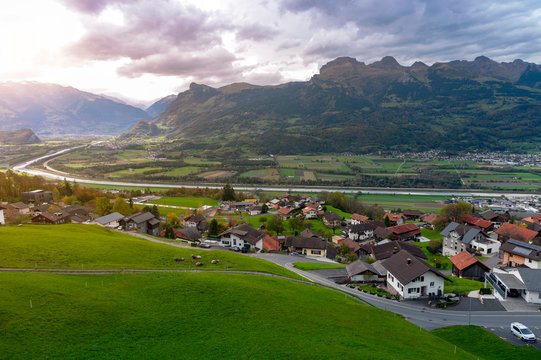 Scenic aerial view of hillside villages in Triesenberg and the river Rhine, natural border of Liechtenstein, an alpine country in central Europe, to Switzerland