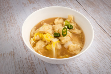 A dish of simmered dough with a background