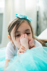 A girl kisses the tiny legs of her newborn sister. - 346137324