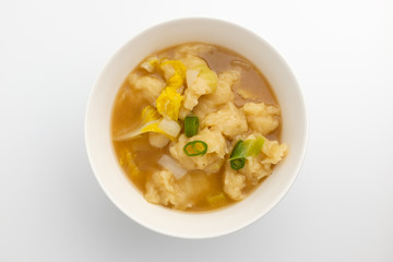 A dish of simmered dough with a background
