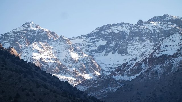 Snowy mountains at winter while Toubkal trek in the Moroccan Atlas, Imlil, Morocco.
Mid angle, panoramic movement, HD.