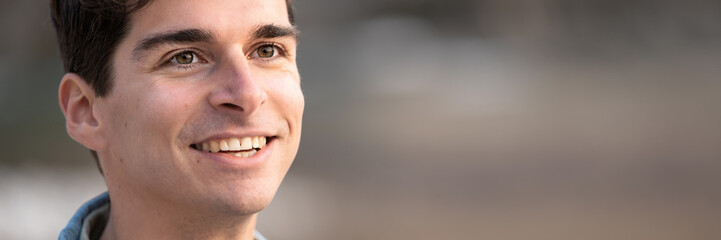 Obraz premium face portrait a beautiful smiling man, panorama