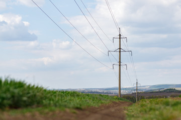 Fototapeta na wymiar high voltage power lines in the field