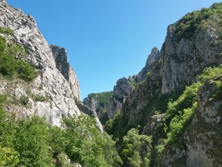 green rocky mountains in spring season on sunny day