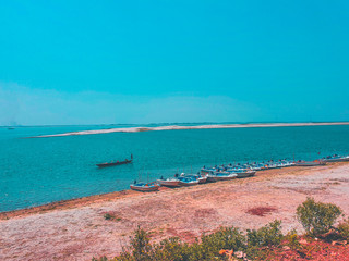 beach and sea with some boats