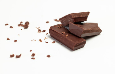 Pieces of chocolate on white background