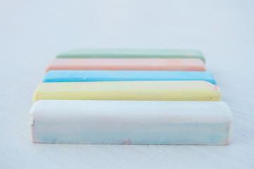 Colorful chalk scattered on a white background.