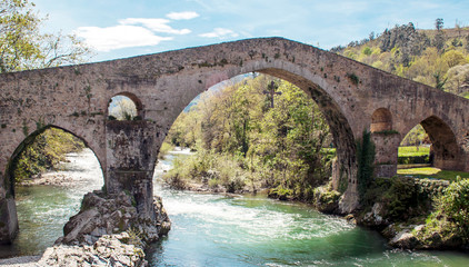 Fototapeta na wymiar Roman bridge of Cangas de Onis in Asturias in a sunny day