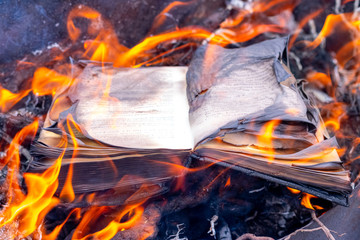 Burning book. The book is on fire. Burning unnecessary books