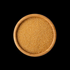 Eco bio brown sugar in wooden bowl isolated on black background