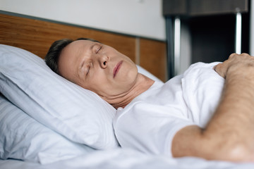 selective focus of man sleeping in bedroom