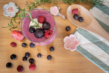 Mixed berries smoothie on wooden table