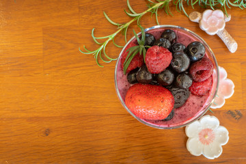 Mixed berries smoothie on wooden table