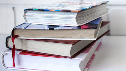 Education. A stack of books on a white background.
