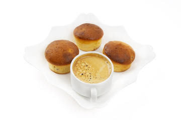 Homemade cupcakes and a cup of coffee on a white square plate isolated on white. Coffee break concept.