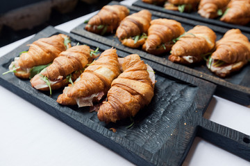 Fresh croissant on wooden table
