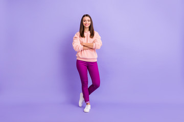 Full length photo of funny pretty lady beaming smiling good mood hold hands crossed ready for walk outside wear casual fur fuzzy sweater pants isolated purple color background