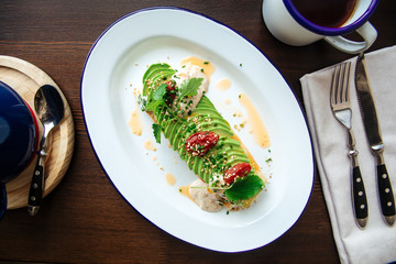 Healthy avocado slices breakfast with sauce