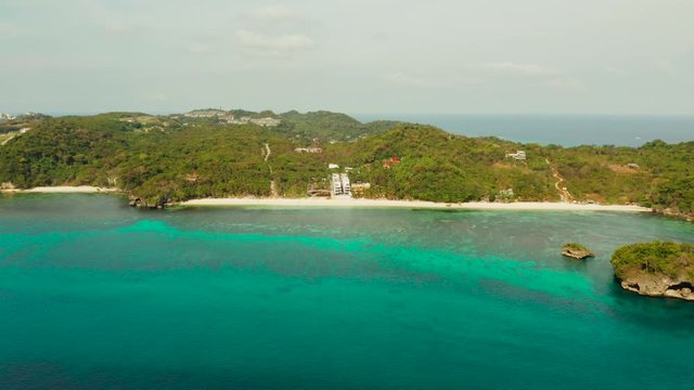 Tropical sandy beach near the blue lagoon and corall reef, aerial view Boracay, Philippines. Ilig Iligan Beach. Summer and travel vacation concept.