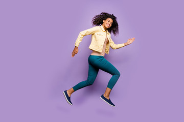 Fototapeta na wymiar Full length body size photo of cheerful positive cute nice girl in pants trousers shirt yellow running jumping isolated pastel violet color background