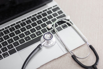 Stethoscope and laptop or computer on doctor desk prepare in hospital and clinic for diagnosis patient health for therapy and treatment with medicine