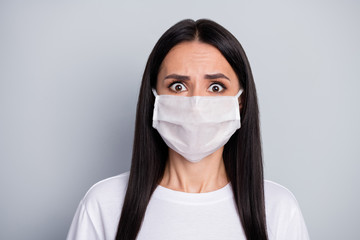 Portrait of shocked terrified girl hear terrible corona virus epidemic spreading news wear medical mask white t-shirt isolated over gray color background