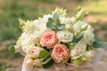 Big flowers arrangement in a wooden hat box was created by a florist for a wedding gift. White Freesia , 
eustoma flowers, roses and eucalyptus in a bouquet. Mother's Day Gift