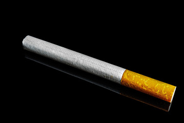 close-up macro of cigarette and filter isolated on black background