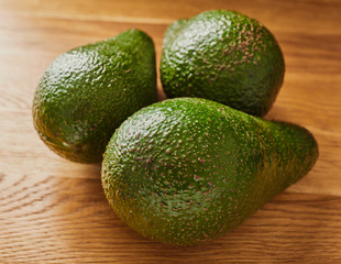 green avocado on a wooden table