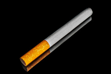 close-up macro of cigarette and filter isolated on black background
