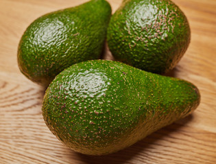 green avocado on a wooden table