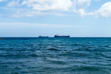 Obraz premium Blue sea, sky and ships on the horizon