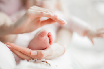 Close up still of baby`s feet. Little toes in mother`s hands. Baby concept. Maternity care.