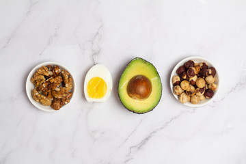 nuts, avocado and eggs on a white background
