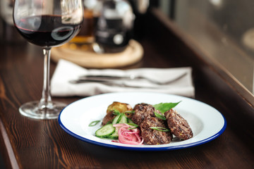 Closeup on small grilled cutlets and mushroom